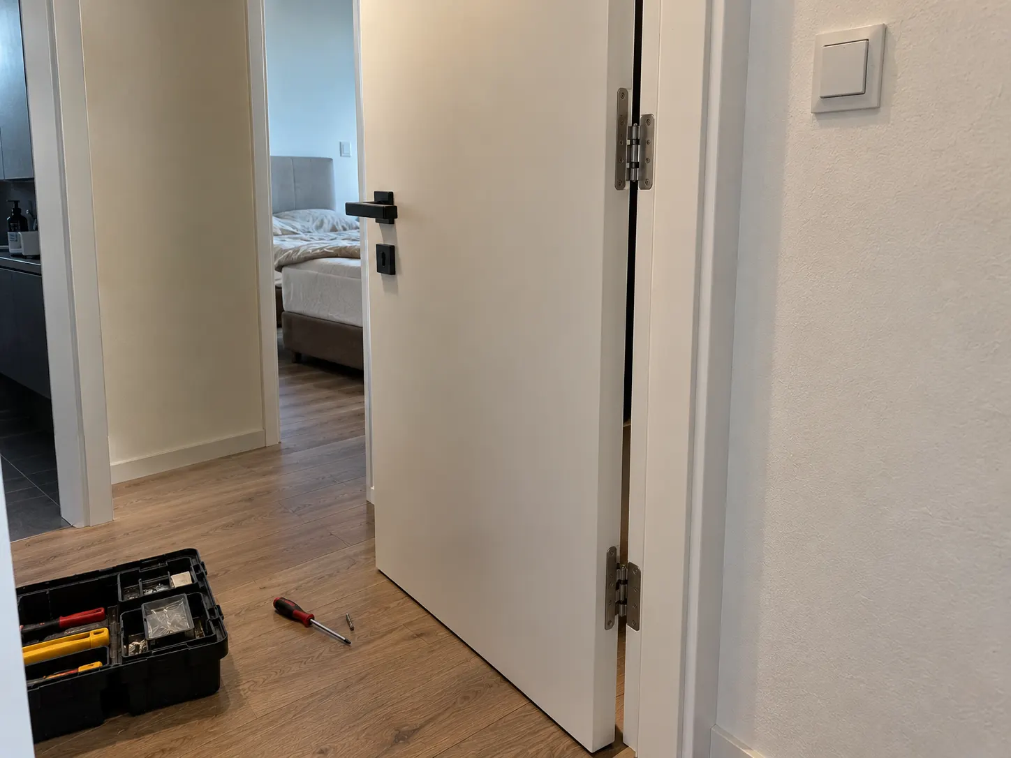 Interior door with hinges and a toolbox